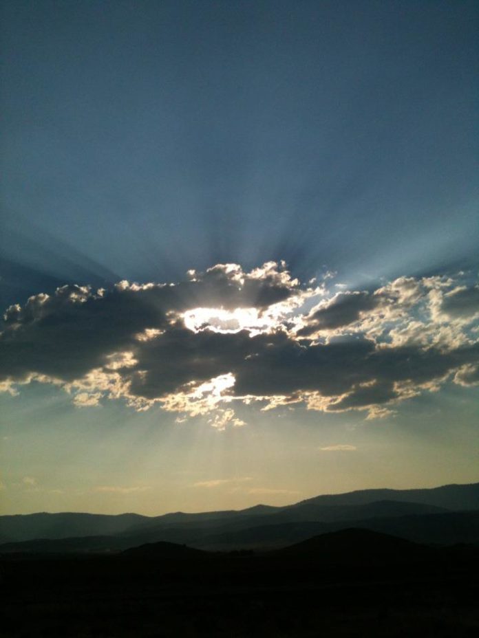 sun behind clouds