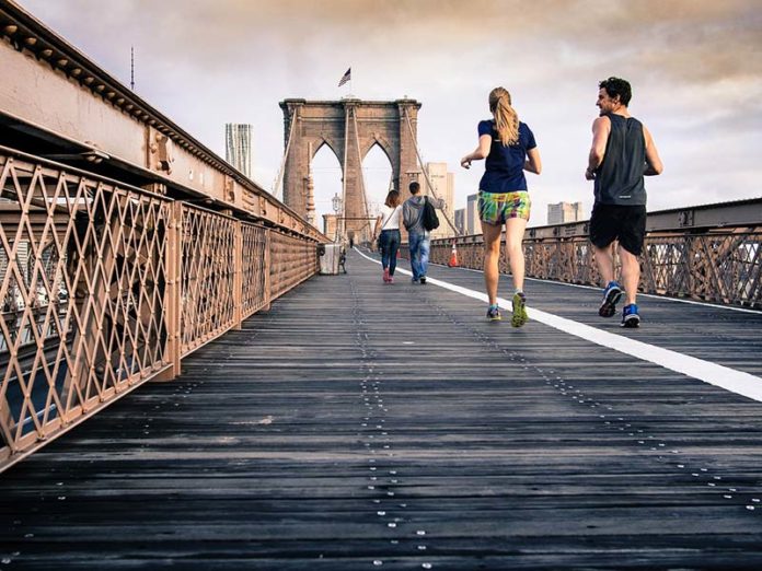 people crossing bridge