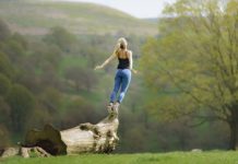 Girl leaping from log