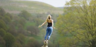 Girl leaping from log