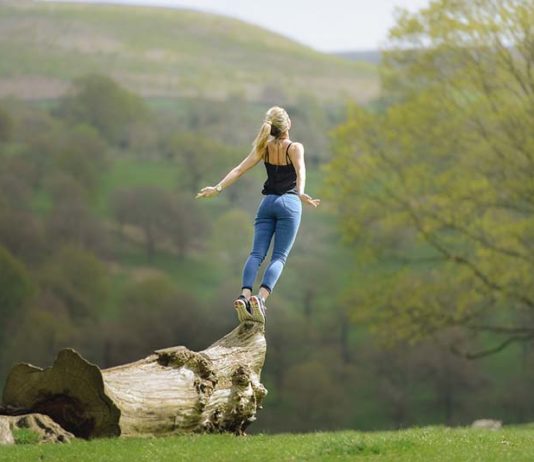 Girl leaping from log