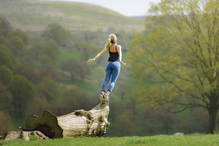 Girl leaping from log