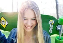 Smiling girl with skateboard