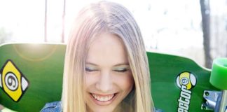 Smiling girl with skateboard