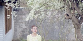 thoughtful girl under tree